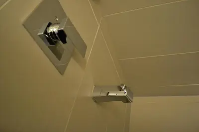 a bathroom with a toilet paper dispenser on the wall at St. Paul Lodge in St. Paul