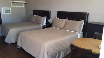 a hotel room with two beds and a table at St. Paul Lodge in St. Paul