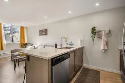 a kitchen with a sink and a dishwasher at Private Town Home with Free Banff Access, Netflix, King Bed, Fully Equipped Kitchen, Sleeps 4 in Calgary