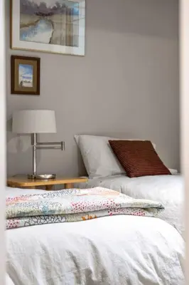 a bedroom with a bed and a table with a lamp at Escape to the Rockies but near Calgary Includes Free Parking and Banff Entry in Calgary