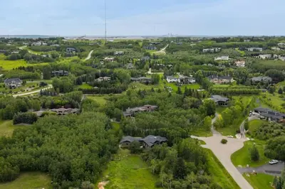 an aerial view of a village with houses and trees at Escape to the Rockies but near Calgary Includes Free Parking and Banff Entry in Calgary