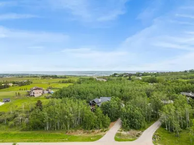 an aerial view of a house on a hill with trees at Escape to the Rockies but near Calgary Includes Free Parking and Banff Entry in Calgary