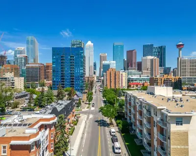 a cityscape of a city with a street and buildings at Downtown Apartment with Underground Parking, Netflix, Fully Equipped Kitchen, Walk to 17th Ave, Sleeps 4, Perfect for Foodies and Tourists in Calgary