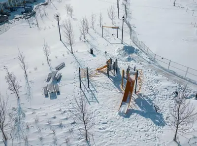 an aerial view of a playground in the snow at 4 Bedroom Town Home with Garage Parking, Fast WiFi, Smart TV with Netflix, Fully Equipped Kitchen, Sleeps 10, Ideal for Families in Airdrie