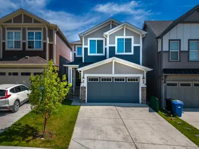 a house with a car parked in front of it at Top Rated Luxury House with Central AC, Double Garage Parking, 2 Kitchens, 5 Bedrooms & More! in Balzac