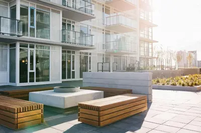 a building with benches in front of a building at Luxury Apartment on the 9th Floor near Stampede, Complimentary Wine, 2 Car UG Parking in Calgary