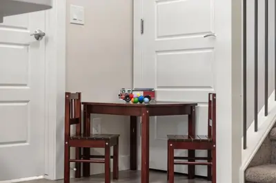 a table with two chairs and a table with balls on it at Private Suite with Queen Bed, Queen Sofa Bed, Netflix, Patio, Sleeps 4 in Calgary