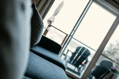 a couch with a pillow in front of a window at Page's Inn on Silva Bay in Gabriola