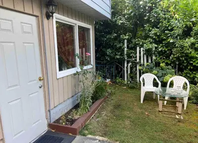 a pair of chairs sitting outside of a house at Friendly and cozy home with separate entrance No Pets Allowed in Burnaby