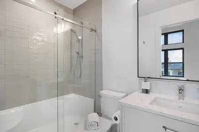 a bathroom with a shower and a toilet and a sink at Coastal Haven at THE BEACH HOUSE in Campbell River