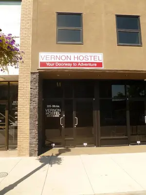 a building with a sign for a veterinary hospital at Vernon Hostel in Vernon