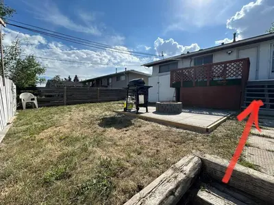 a yard with an orange arrow pointing to a house at Forth Street 2Bedroom Suite in Calgary
