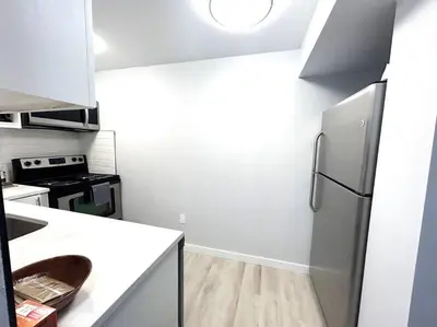 a kitchen with a refrigerator and a stove at Forth Street 2Bedroom Suite in Calgary