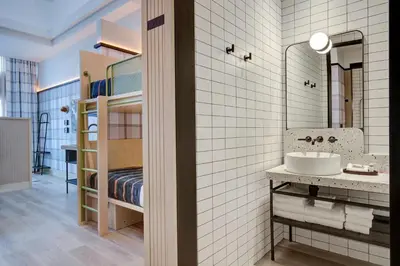 a bathroom with a sink and a bunk bed at Moxy Banff in Banff