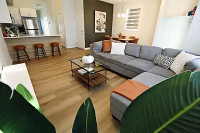 a living room with a couch and a table at Downtown 3 Queen Beds, AC, Double Garage, Disney in Edmonton