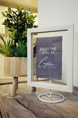 a picture frame sitting on a table next to a plant at Downtown Suite King Beds,Long Stays,Disney+ in Edmonton