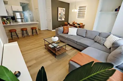 a living room with a couch and a table at Downtown 5 Bedroom, AC, Rogers, Commonwealth, EXPO in Edmonton