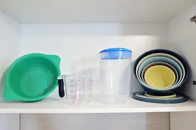 a shelf with various kitchen utensils on it at Central Suite King Beds,Long Stays,Disney+ in Edmonton