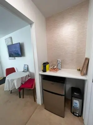 a room with a desk and a table with a red chair at 'Canyon Heights' Retreat (Grouse Mountain) in North Vancouver