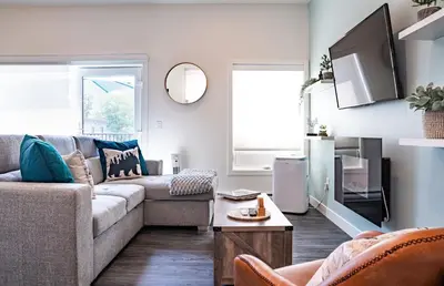 a living room with a couch and a table at Peak Paradise by Revelstoke Vacations in Revelstoke