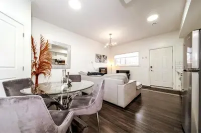 a living room with a couch and a table at Chic Suite - Long Stays - King Bed - Fireplace & WiFi in Edmonton