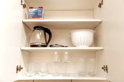 a shelf with wine glasses and a blender on it at Chic Suite - Long Stays - King Bed - Fireplace & WiFi in Edmonton
