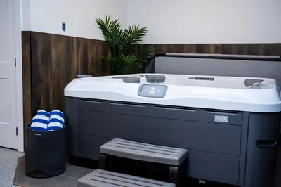 a jacuzzi tub in the corner of a room at The Stellar Condo - Cozy 2 Bedroom with Hot Tub in Revelstoke