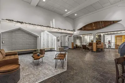 a large room with a couch and tables and chairs at W116 NEW! Central Canmore- Whimsical Mountain Retreat in Canmore