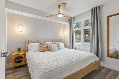 a bedroom with a large bed and a window at W116 NEW! Central Canmore- Whimsical Mountain Retreat in Canmore