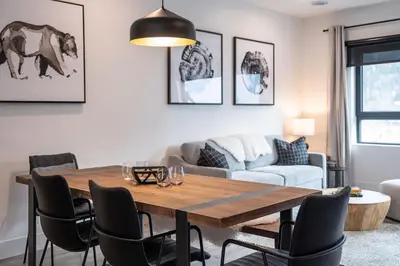 a living room with a table and chairs at Altitude Adjustment by Revelstoke Vacations in Revelstoke