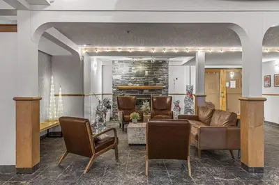 a living room with a couch and chairs at W118 NEW! Central Canmore- Light Industrial Hotel Room in Canmore