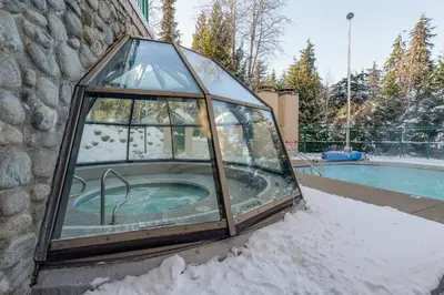 a glass igloo with a swimming pool in the snow at 1BR in Marquise, Near Ski Hill, Fireplace, Heated Pool, Hot Tub, Sauna, Gym, Free Shuttle in Whistler