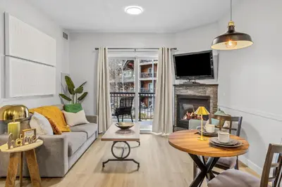 a living room with a couch and a fireplace at G222 Family Fun- MTN View Stay, Water slide, Pool, Hot Tub, Free Parking in Canmore