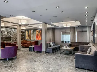 a lobby with couches and chairs and tables at G222 Family Fun- MTN View Stay, Water slide, Pool, Hot Tub, Free Parking in Canmore