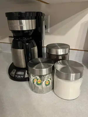 a coffee maker and two containers next to a coffee pot at Waterfront, Mountainview House in Castlegar in Castlegar