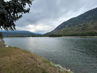 a body of water with mountains in the background at Waterfront, Mountainview House in Castlegar in Castlegar