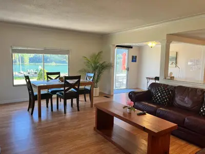 a living room with a couch and a table at Waterfront, Mountainview House in Castlegar in Castlegar