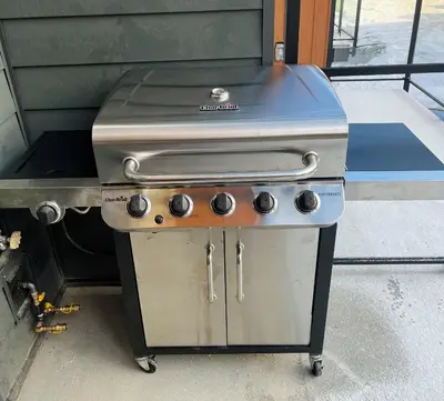 a gas grill sitting on a trailer in a garage at Ski In Ski Out Private Hot Tub in Panorama