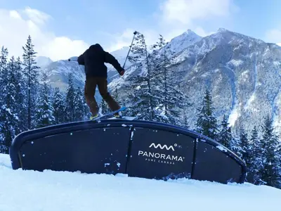 a person on skis on a tv in the snow at Ski In Ski Out Private Hot Tub in Panorama