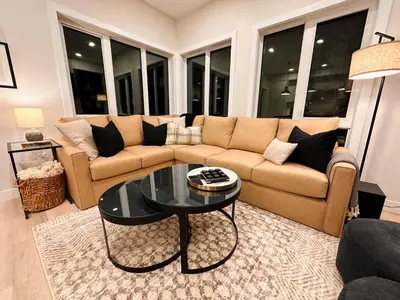 a living room with a couch and a table at Ski In Ski Out Private Hot Tub in Panorama