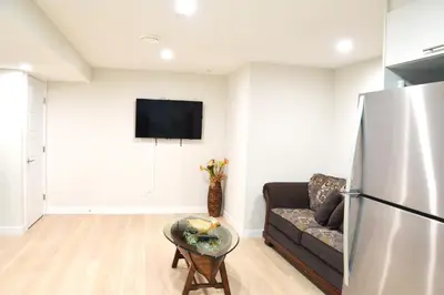 a living room with a couch and a refrigerator at Secondary Suite, Separate Entrance NW Calgary in Calgary