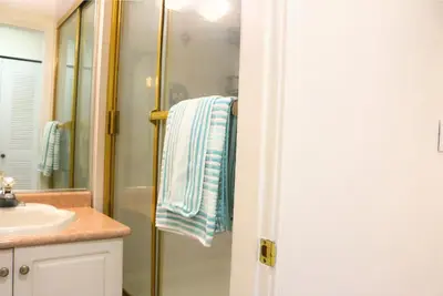 a bathroom with a shower and a sink and a towel at Pristine 3 Beds 2 Washroom Guest Suite in Surrey