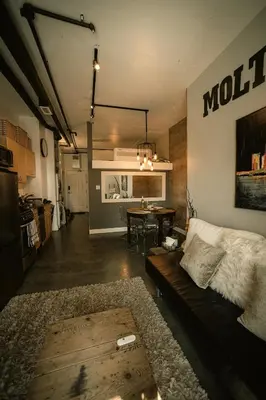 a living room with a couch and a table at 2 Full Beds, Free Parking Underground Heated, Rogers Place, 1 Bedroom Condo Downtown Central in Edmonton
