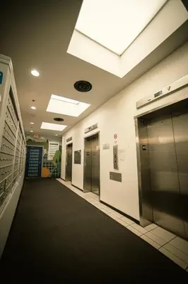 an empty hallway with elevators in a office building at 2 Full Beds, Free Parking Underground Heated, Rogers Place, 1 Bedroom Condo Downtown Central in Edmonton