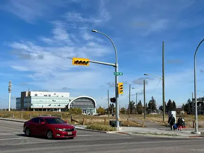 a red car stopped at a traffic light at an intersection at Lovely comfy home private bath in central Calgary in Calgary