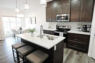 a kitchen with a sink and a stove top oven at Three King Beds,Central A/C,Fireplace,Park,Disney+ in Edmonton
