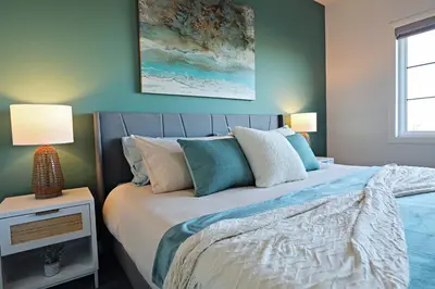 a bedroom with a bed with two lamps on it at Three King Beds,Central A/C,Fireplace,Park,Disney+ in Edmonton