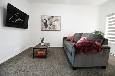 a living room with a couch and a table at Three King Beds,Central A/C,Fireplace,Park,Disney+ in Edmonton