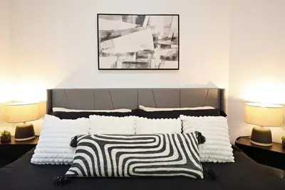 a bedroom with a bed with two lamps at Three King Beds,Central A/C,Fireplace,Park,Disney+ in Edmonton