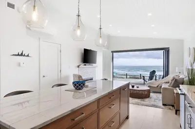 a kitchen with a view of the ocean at Beachfront Luxury Suite #15 at THE BEACH HOUSE in Campbell River